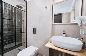 a bathroom with a toilet and a sink and a shower at Escape Vama Veche in Vama Veche
