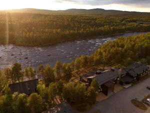 an aerial view of a house next to a river at Wilderness Hotel Juutua in Inari +68 photos