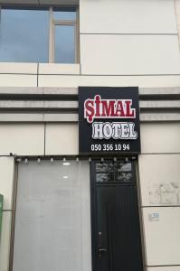 a sign for a hotel on the side of a building at Şimal Hotel in Quba