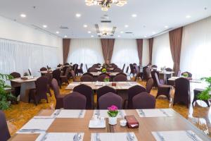 a conference room with tables and chairs and windows at Sai Gon Da Lat Premium in Da Lat +52 photos