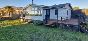 a tiny house with a porch and a deck at The waterfront retreat in Lock Sport