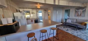 a kitchen and living room with a counter and stools at The waterfront retreat in Lock Sport +24 photos