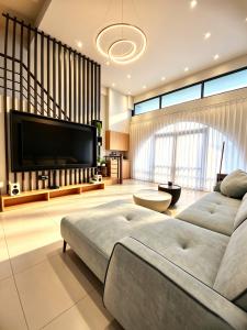 a living room with a couch and a large television at 大溪漁港蜜月灣Luna民宿 in Fan-shu-liao