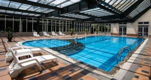 a large swimming pool with chairs in a building at Sai Gon Da Lat Premium in Da Lat