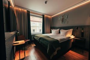 a hotel room with a bed and a window at Clarion Hotel Mestari in Helsinki