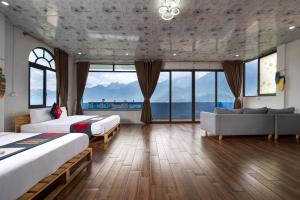 a hotel room with two beds and a couch at Catcat Garden House in Sapa +179 photos
