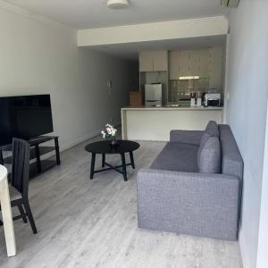 a living room with a couch and a table at Olympicpark 12 Free Parking in Sydney