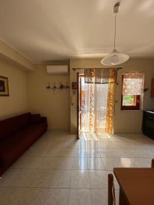 a living room with a couch and a window at Casa Le Araucarie in Mascali