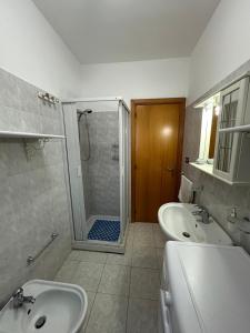 a bathroom with two sinks and a shower at Casa Le Araucarie in Mascali +9 photos