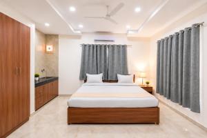 a bedroom with a large bed in a room at Hotel Meridian Sector 132, Near Max Hospital in Noida