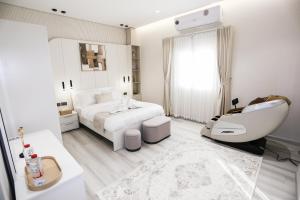 a white bedroom with a bed and a white sink at paradise resort and spa in Hatta +40 photos