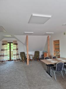 a room with tables and chairs in a room at Spełnienie Marzeń Bóbrka in Bóbrka