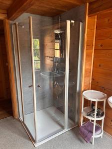 a glass shower in a room with a stool at Reiter- und Ferienhof Wacker in Schöna +44 photos