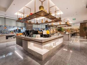 a restaurant with a counter in a large room at Radisson Hotel, Beijing DaXing Airport in Beijing