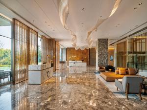 a large lobby with a couch and a large chandelier at Radisson Hotel, Beijing DaXing Airport in Beijing +50 photos