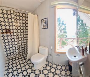 a bathroom with a toilet and a sink at Magpie Retreat in Bhīm Tāl +38 photos