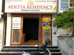 a scooter parked in front of a building at Aditya Residency, Bhagalpur in Barāri