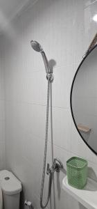 a shower in a bathroom with a sink and a mirror at Papa house in Pak Kret