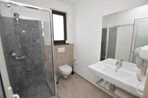 a bathroom with a shower and a toilet and a sink at Riana in Adjud +40 photos