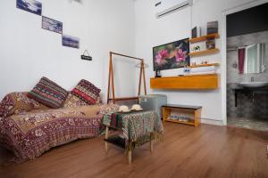 a living room with a couch and a table at Catcat Garden House in Sapa