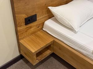 a bed with a built in nightstand next to a bed sidx sidx at Da Vinci Hotel in Almaty