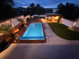 an overhead view of a swimming pool at night at Casa Urbano Mall- Floresti in Floreşti
