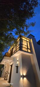 a white building with a lot of windows on it at Desert Oasis Camp And Resort in ladakh