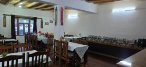 a dining room with tables and chairs in a restaurant at Desert Oasis Camp And Resort in ladakh