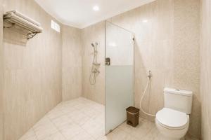 a bathroom with a toilet and a glass shower at Oak Lawang in Lawang +52 photos