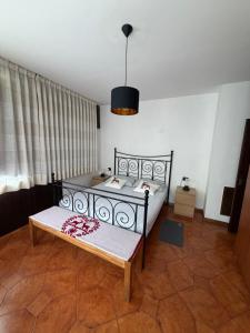 a bedroom with a bed and a table in it at Mountain Apartments Tarvisio in Tarvisio
