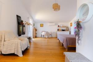 a living room with two beds and a dining room at Le Spa des lavandes panoramique in Valensole