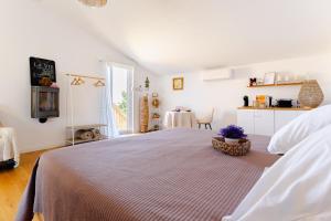 a white bedroom with a large bed and a table at Le Spa des lavandes panoramique in Valensole