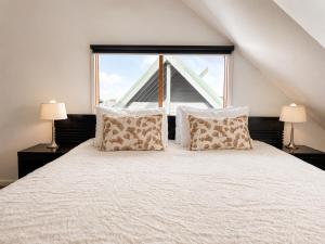 a bedroom with a bed with a large window at Cape Cod Chalet, alpine-getaways in Dinner Plain
