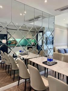a dining room with tables and chairs at Amanda Apartment Quy Nhon in Quy Nhon