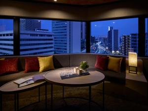 a living room with a couch and a large window at Minn Namba South in Osaka