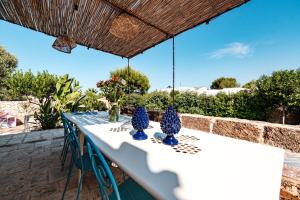 a table with blue vases on top of it at Villa Gemma - Sea Access & Private Pool in Polignano a Mare +50 photos
