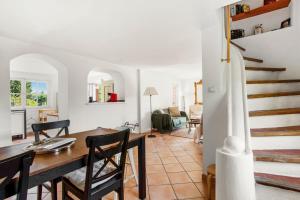 a dining room and living room with a table and chairs at La Villa Andéria in Callian