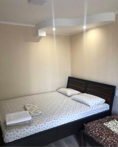 a bedroom with a bed with two pillows on it at Comfort in Reni