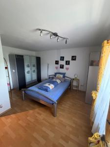 a bedroom with a blue bed in a room at Haus Franz in Zandt