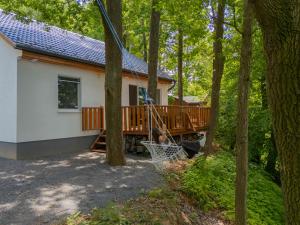 a cabin in the woods with a porch at Fácán Fészek Vendégház in Mátraszentimre