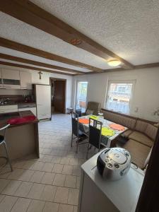 a kitchen and a living room with a table and chairs at Haus Franz in Zandt