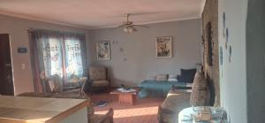 a living room with a couch and a bed at Over the Rainbow Guest House in Hibberdene +38 photos