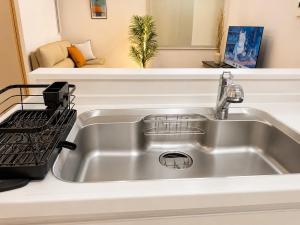 a kitchen sink with a drying rack next to it at OTE HOUSE shime in Shime +32 photos