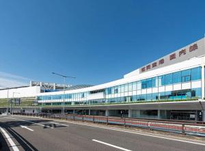 a large white building with a road in front of it at OTE HOUSE shime in Shime