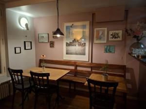 a dining room with a wooden table and chairs at Hotel & Bistro Pêle-Mêle in Bern +18 photos