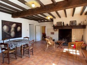 a living room with a table and chairs and a fireplace at Chez cazalets in Susmiou