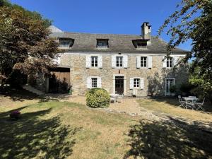 a large stone house with a large yard at Chez cazalets in Susmiou