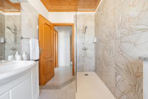 a bathroom with a sink and a shower at Casa Vacanza Iris in Perdaxius +22 photos