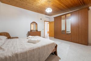 a bedroom with a bed with two towels on it at Casa Vacanza Iris in Perdaxius
