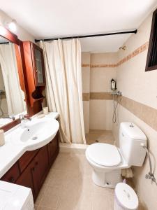 a bathroom with a toilet and a sink at Mani Spot Elmare in Okhiá +18 photos